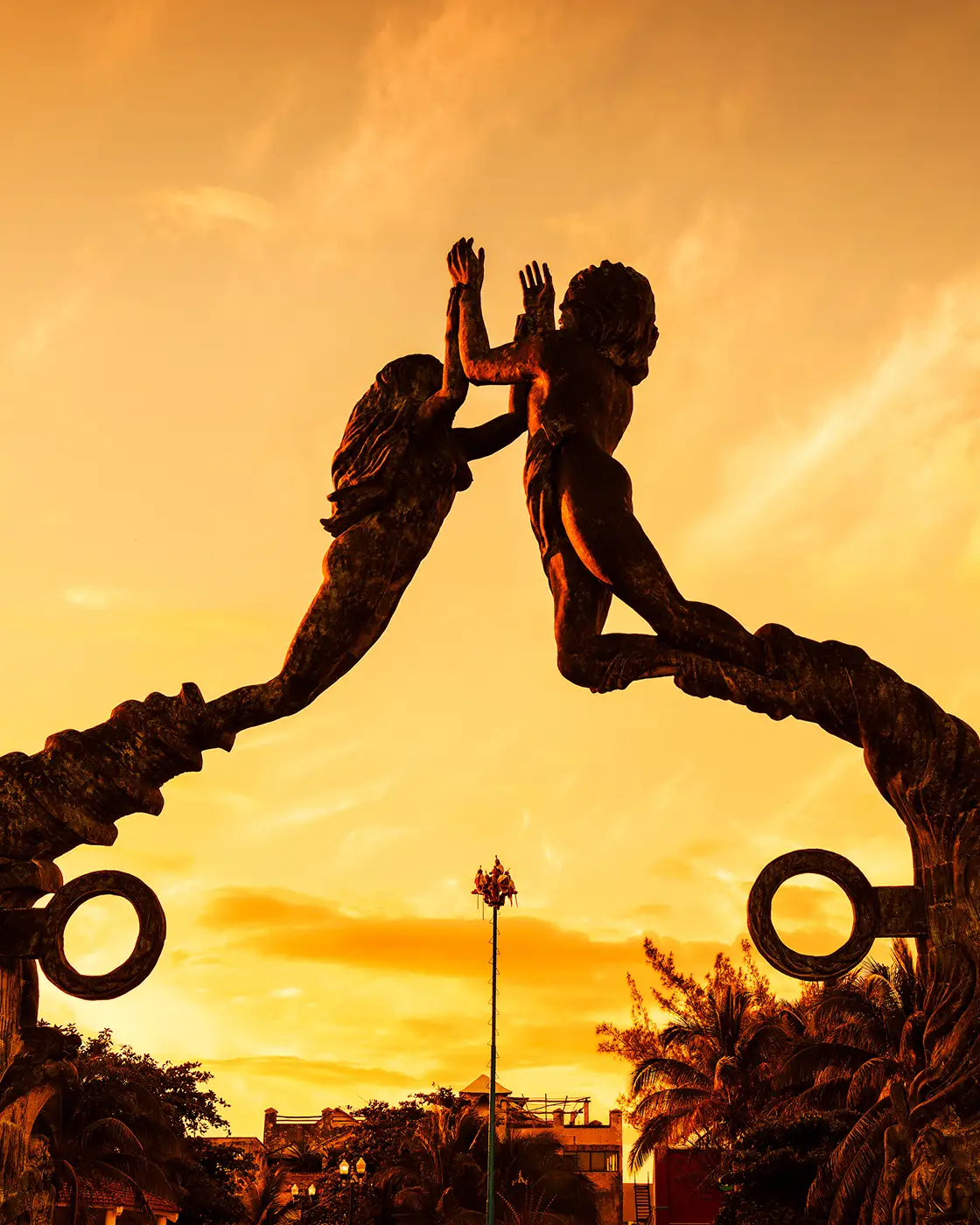 Portal Maya sculpture on Fifth Avenue in Playa del Carmen at sunset