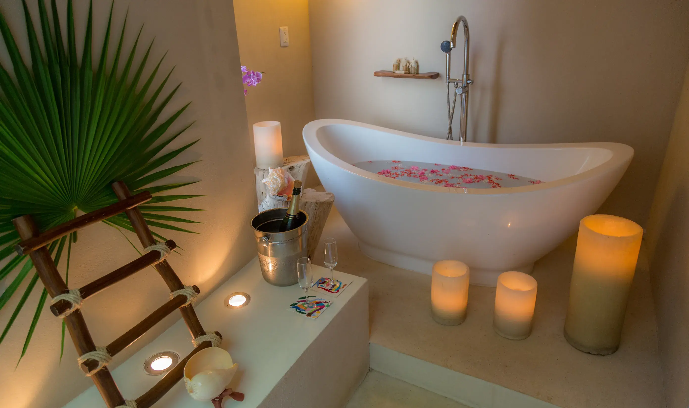 Bathtub with flower petals and candles for a spa ritual