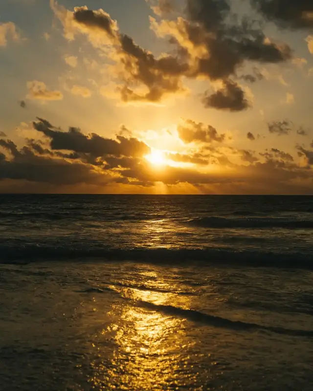 Sunset over the Caribbean Sea seen from Mahekal Beach Resort's beach